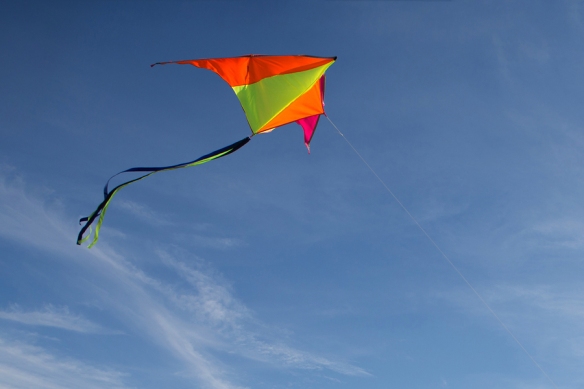 Flying A Kite. Bright Kite Against The Blue Sky. Sunny Day. Sky
